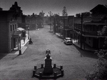 Movie still from “The Wild One” (1953), directed by Laslo Benedek – An old photo of an empty street with a statue in the middle; Extreme Wide shot, High angle