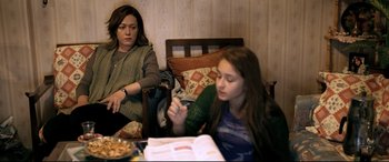 Movie still from “The Wild Pear Tree” (2018), directed by Nuri Bilge Ceylan – A woman sitting next to a girl at a table; Medium shot, High angle