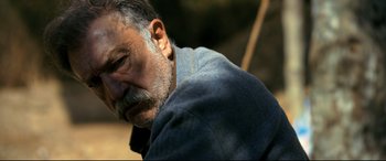 Movie still from “The Wild Pear Tree” (2018), directed by Nuri Bilge Ceylan – An older man with a gray beard is looking down; Close Up shot, Low angle