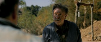 Movie still from “The Wild Pear Tree” (2018), directed by Nuri Bilge Ceylan – An old man with a beard and a mustache; Close Up shot, Over the shoulder angle