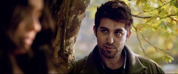 Movie still from “The Wild Pear Tree” (2018), directed by Nuri Bilge Ceylan – A man's face in front of a tree; Close Up shot, Over the shoulder angle