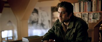 Movie still from “The Wild Pear Tree” (2018), directed by Nuri Bilge Ceylan – A man sitting at a table looking at the camera; Close Up shot, Low angle