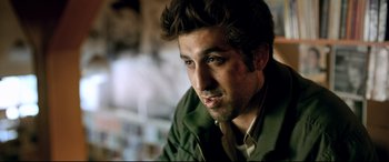 Movie still from “The Wild Pear Tree” (2018), directed by Nuri Bilge Ceylan – A person wearing a green jacket; Close Up shot, Over the shoulder angle