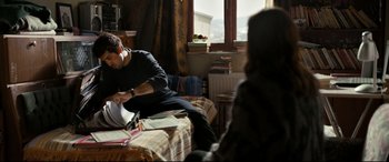 Movie still from “The Wild Pear Tree” (2018), directed by Nuri Bilge Ceylan – A man sitting on top of a bed next to a woman; Medium shot, Over the shoulder angle