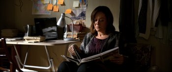 Movie still from “The Wild Pear Tree” (2018), directed by Nuri Bilge Ceylan – A woman sitting at a desk looking at a magazine; Medium shot, High angle