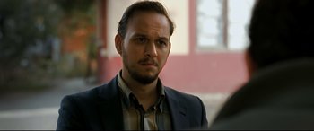 Movie still from “The Wild Pear Tree” (2018), directed by Nuri Bilge Ceylan – A person wearing a suit and tie; Close Up shot, Over the shoulder angle