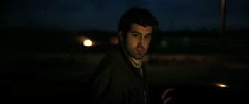 Movie still from “The Wild Pear Tree” (2018), directed by Nuri Bilge Ceylan – A man in a jacket standing in the dark at night; Close Up shot, Low angle