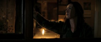 Movie still from “The Wild Pear Tree” (2018), directed by Nuri Bilge Ceylan – A woman standing in front of a window at night; Medium shot, Low angle