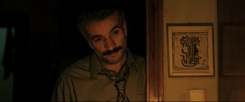 Movie still from “The Wild Pear Tree” (2018), directed by Nuri Bilge Ceylan – A man with a mustache wearing a neck tie; Close Up shot, Low angle