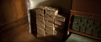 Movie still from “The Wild Pear Tree” (2018), directed by Nuri Bilge Ceylan – A stack of boxes sitting on top of each other in a room; Medium shot, High angle