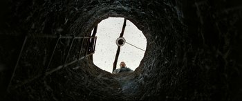 Movie still from “The Wild Pear Tree” (2018), directed by Nuri Bilge Ceylan – A man standing inside of a hole in the ground; Wide shot, Overhead angle