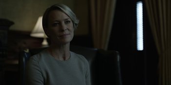 Movie still from “House of Cards” (2013), created by Beau Willimon – A person sitting in a chair; Close Up shot, Over the shoulder angle