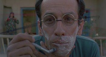Movie still from “The Wind Will Carry Us” (1999), directed by Abbas Kiarostami – A man with glasses is shaving his face; Extreme Close Up shot, Low angle