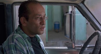 Movie still from “The Wind Will Carry Us” (1999), directed by Abbas Kiarostami – A man wearing glasses looking out of a window; Close Up shot, Low angle