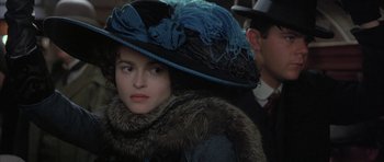 Movie still from “The Wings of the Dove” (1997), directed by Iain Softley – A woman in a hat and a fur coat; Close Up shot, Over the shoulder angle