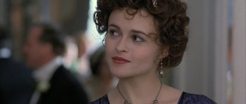 Movie still from “The Wings of the Dove” (1997), directed by Iain Softley – A person wearing a necklace and earrings; Close Up shot, Over the shoulder angle