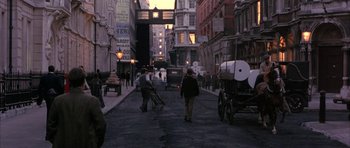 Movie still from “The Wings of the Dove” (1997), directed by Iain Softley – A street scene with people walking down the sidewalk; Wide shot, High angle