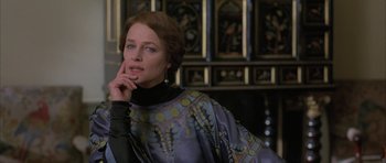 Movie still from “The Wings of the Dove” (1997), directed by Iain Softley – A woman in a black top and a purple and black dress; Close Up shot, Over the shoulder angle