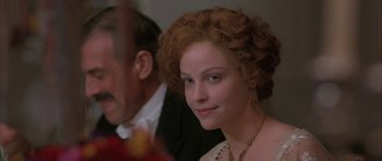 Movie still from “The Wings of the Dove” (1997), directed by Iain Softley – A person with curly hair wearing a necklace; Close Up shot, Over the shoulder angle