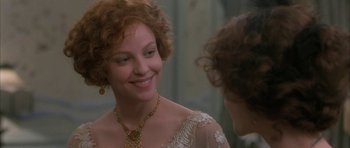 Movie still from “The Wings of the Dove” (1997), directed by Iain Softley – A woman in a white dress smiling at another woman in a white dress; Close Up shot, Over the shoulder angle