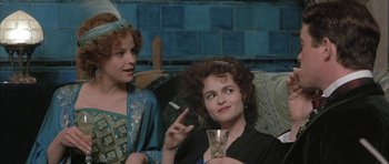 Movie still from “The Wings of the Dove” (1997), directed by Iain Softley – Two women sitting next to each other on a couch; Medium shot, Over the shoulder angle