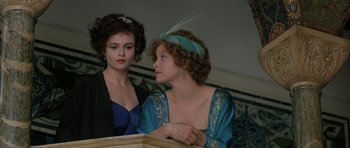 Movie still from “The Wings of the Dove” (1997), directed by Iain Softley – Two women are sitting next to each other; Close Up shot, High angle