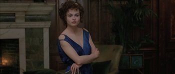 Movie still from “The Wings of the Dove” (1997), directed by Iain Softley – A woman in a blue dress posing for a picture; Medium shot, Over the shoulder angle
