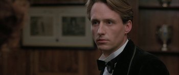 Movie still from “The Wings of the Dove” (1997), directed by Iain Softley – A person wearing a suit and bow tie; Close Up shot, Low angle