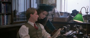Movie still from “The Wings of the Dove” (1997), directed by Iain Softley – A man and a woman sitting next to each other in a room; Medium shot, Over the shoulder angle