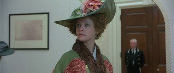 Movie still from “The Wings of the Dove” (1997), directed by Iain Softley – A woman wearing a hat and a green coat; Close Up shot, Low angle