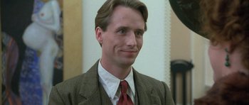 Movie still from “The Wings of the Dove” (1997), directed by Iain Softley – A person wearing a suit and tie; Close Up shot, Low angle