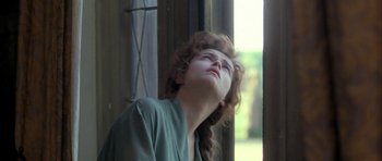 Movie still from “The Wings of the Dove” (1997), directed by Iain Softley – A woman with her head tilted to the side; Close Up shot, Low angle
