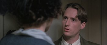 Movie still from “The Wings of the Dove” (1997), directed by Iain Softley – A man looking at another man in a room; Close Up shot, Over the shoulder angle