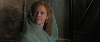 Movie still from “The Wings of the Dove” (1997), directed by Iain Softley – A woman with red curly hair wearing a blue veil; Close Up shot, Low angle