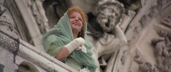 Movie still from “The Wings of the Dove” (1997), directed by Iain Softley – A woman in a green dress and white gloves is smiling; Close Up shot, Low angle