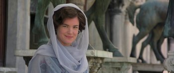 Movie still from “The Wings of the Dove” (1997), directed by Iain Softley – A woman wearing a white head scarf and a blue dress; Close Up shot, Over the shoulder angle