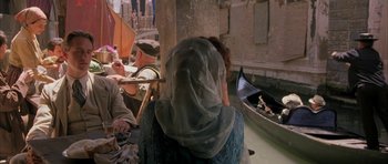 Movie still from “The Wings of the Dove” (1997), directed by Iain Softley – A group of people sitting in a boat on a river; Medium shot, Over the shoulder angle