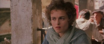 Movie still from “The Wings of the Dove” (1997), directed by Iain Softley – A person wearing a scarf; Close Up shot, Over the shoulder angle