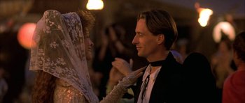 Movie still from “The Wings of the Dove” (1997), directed by Iain Softley – A man and a woman are holding each other; Close Up shot, Low angle