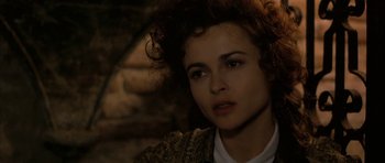 Movie still from “The Wings of the Dove” (1997), directed by Iain Softley – A person with curly red hair; Close Up shot, Over the shoulder angle