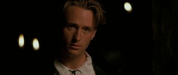 Movie still from “The Wings of the Dove” (1997), directed by Iain Softley – A person wearing a suit and tie; Close Up shot, Over the shoulder angle