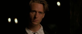 Movie still from “The Wings of the Dove” (1997), directed by Iain Softley – A person wearing a suit and tie; Close Up shot, Over the shoulder angle