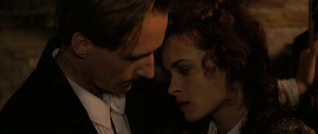 Movie still from “The Wings of the Dove” (1997), directed by Iain Softley – A man and a woman face to face in the dark; Close Up shot, Low angle