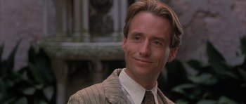 Movie still from “The Wings of the Dove” (1997), directed by Iain Softley – A man that is wearing a suit and tie; Close Up shot, Low angle