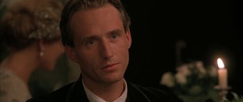 Movie still from “The Wings of the Dove” (1997), directed by Iain Softley – A man that is looking at the camera; Close Up shot, Over the shoulder angle