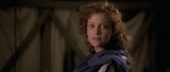 Movie still from “The Wings of the Dove” (1997), directed by Iain Softley – A person with curly hair wearing a scarf; Close Up shot, Low angle
