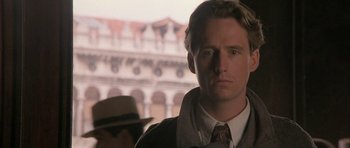 Movie still from “The Wings of the Dove” (1997), directed by Iain Softley – A person wearing a suit and tie; Close Up shot, Low angle