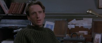 Movie still from “The Wings of the Dove” (1997), directed by Iain Softley – A person sitting in a chair wearing a sweater; Close Up shot, Over the shoulder angle
