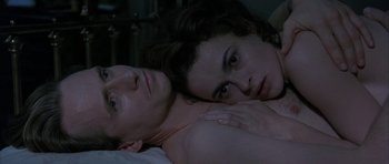 Movie still from “The Wings of the Dove” (1997), directed by Iain Softley – A man and a woman laying in bed together; Close Up shot, High angle