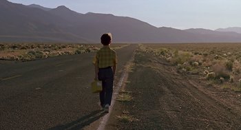 Movie still from “The Wizard” (1989), directed by Todd Holland – A boy is walking down the middle of the road; Wide shot, Low angle
